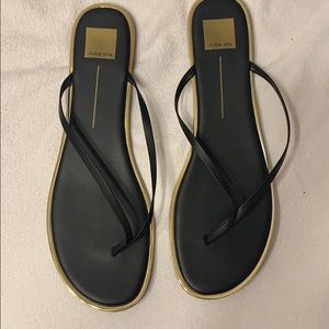 Dolce Vita black flip flops with gold trim